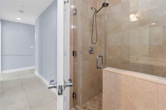 1060 Brickell Ave Unit 1811, Miami, FL 33131 - bathroom featuring a shower stall, baseboards, and tile patterned flooring