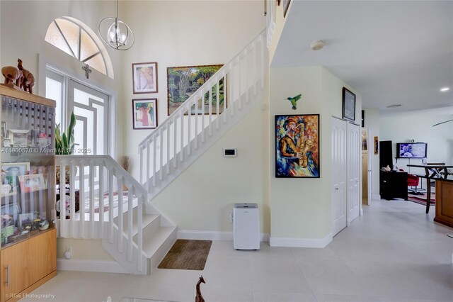 621 NW 157th Ave, Pembroke Pines, FL 33028 - stairway with a chandelier, baseboards, and tile patterned flooring
