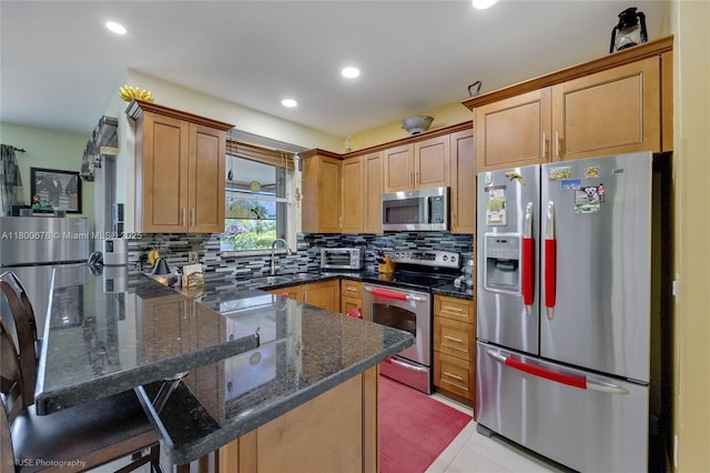 621 NW 157th Ave, Pembroke Pines, FL 33028 - kitchen with stainless steel appliances, a sink, a peninsula, decorative backsplash, and dark stone countertops