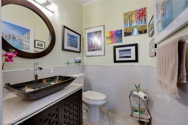 621 NW 157th Ave, Pembroke Pines, FL 33028 - bathroom featuring vanity, toilet, tile walls, crown molding, and wainscoting