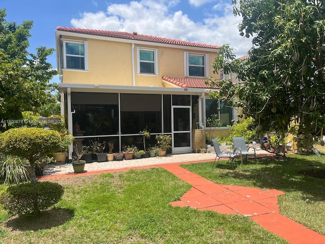 621 NW 157th Ave, Pembroke Pines, FL 33028 - rear view of house featuring a tile roof, a sunroom, a yard, and stucco siding