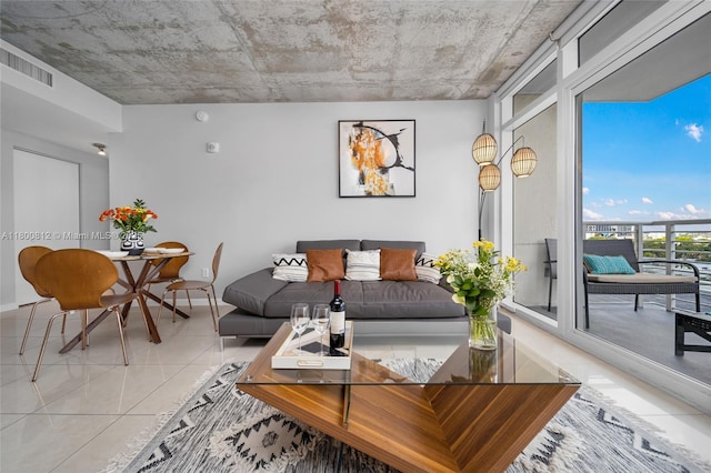 3250 NE 1st Ave Unit 806, Miami, FL 33137 - living area featuring light tile patterned floors, floor to ceiling windows, and baseboards