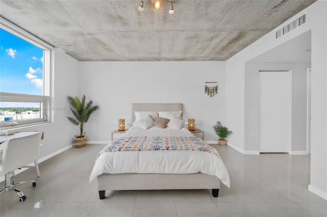 3250 NE 1st Ave Unit 806, Miami, FL 33137 - bedroom with baseboards and tile patterned flooring