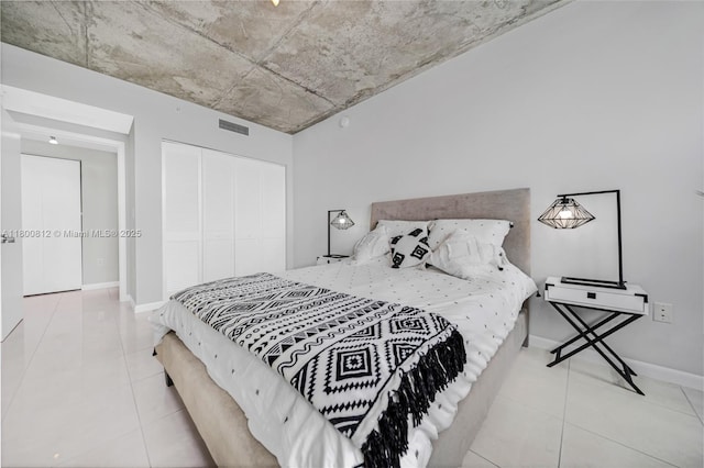 3250 NE 1st Ave Unit 806, Miami, FL 33137 - bedroom with tile patterned flooring, a closet, and baseboards