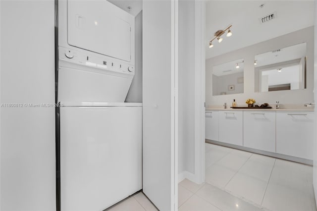 3250 NE 1st Ave Unit 806, Miami, FL 33137 - laundry room with stacked washing machine and dryer and light tile patterned flooring