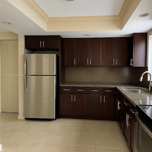 800 NE 199th St Unit 105D, Miami, FL 33179 - kitchen featuring stainless steel appliances, a raised ceiling, a sink, ornamental molding, and decorative backsplash