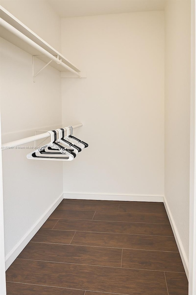800 NE 199th St Unit 105D, Miami, FL 33179 - walk in closet featuring dark wood-type flooring