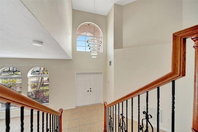 13781 NW 16th St, Pembroke Pines, FL 33028 - entrance foyer featuring healthy amount of natural light, a towering ceiling, light tile patterned floors, and baseboards
