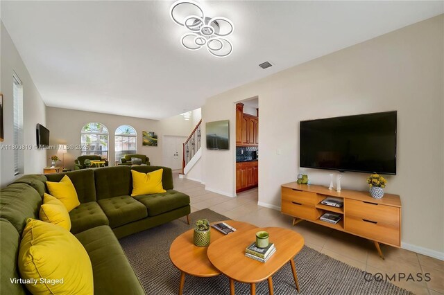 13781 NW 16th St, Pembroke Pines, FL 33028 - living area with light tile patterned floors, stairway, and baseboards