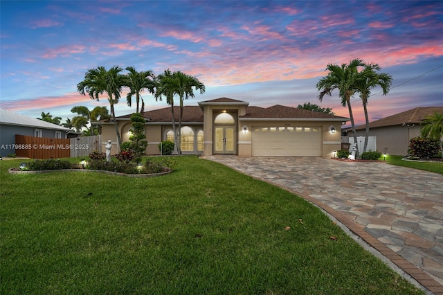 4344 Agualinda Blvd, Cape Coral, FL 33914 - single story home with stucco siding, an attached garage, decorative driveway, and a front yard