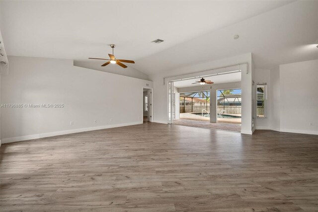 4344 Agualinda Blvd, Cape Coral, FL 33914 - unfurnished living room featuring ceiling fan, wood finished floors, baseboards, and vaulted ceiling