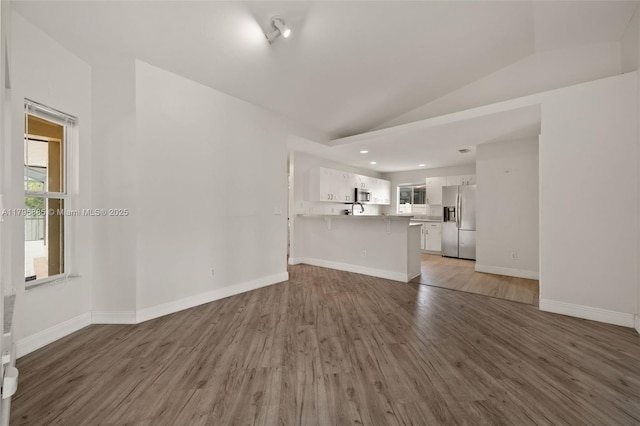 4344 Agualinda Blvd, Cape Coral, FL 33914 - unfurnished living room with wood finished floors, plenty of natural light, vaulted ceiling, baseboards, and recessed lighting