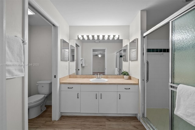 4344 Agualinda Blvd, Cape Coral, FL 33914 - bathroom with wood finished floors, a stall shower, vanity, and toilet