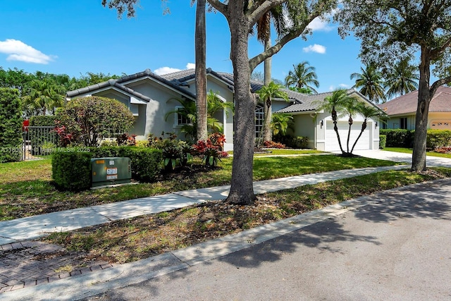 218 Egret Ct, Weston, FL 33327 - view of front of home with a garage, a tile roof, stucco siding, a front lawn, and concrete driveway