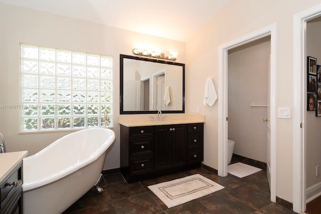 218 Egret Ct, Weston, FL 33327 - full bathroom featuring vanity, a freestanding bath, baseboards, and toilet