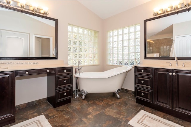 218 Egret Ct, Weston, FL 33327 - full bath with vaulted ceiling, a freestanding tub, vanity, a tile shower, and baseboards