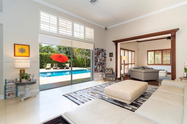 218 Egret Ct, Weston, FL 33327 - tiled living room featuring crown molding, baseboards, and a towering ceiling