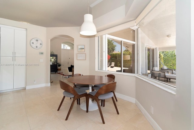 218 Egret Ct, Weston, FL 33327 - dining area featuring arched walkways, light tile patterned flooring, and baseboards