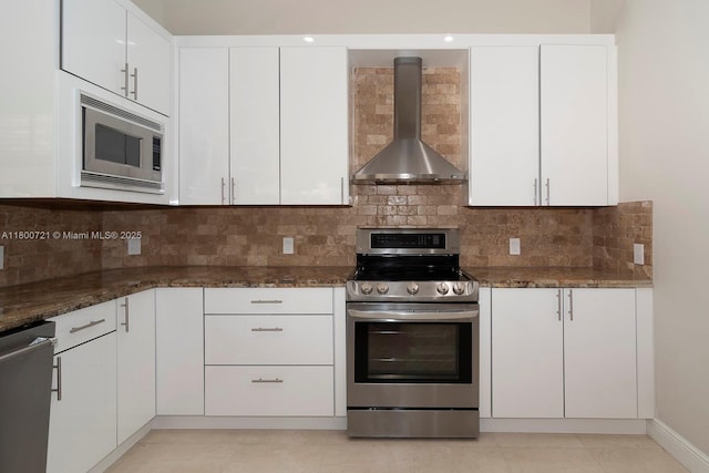 218 Egret Ct, Weston, FL 33327 - kitchen with stainless steel appliances, wall chimney range hood, dark stone counters, and white cabinetry