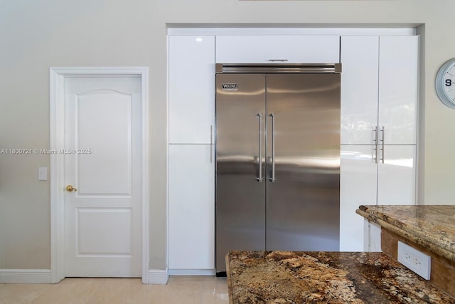 218 Egret Ct, Weston, FL 33327 - kitchen featuring built in fridge, white cabinets, dark stone countertops, and baseboards