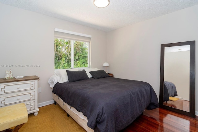218 Egret Ct, Weston, FL 33327 - bedroom featuring baseboards, wood finished floors, and a textured ceiling