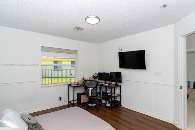 218 Egret Ct, Weston, FL 33327 - bedroom featuring wood finished floors, a wainscoted wall, a textured ceiling, and an office area