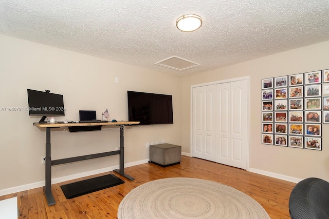 218 Egret Ct, Weston, FL 33327 - living area featuring wood finished floors, a textured ceiling, baseboards, and attic access