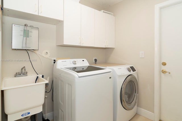 218 Egret Ct, Weston, FL 33327 - laundry room featuring cabinet space, washer and clothes dryer, and baseboards