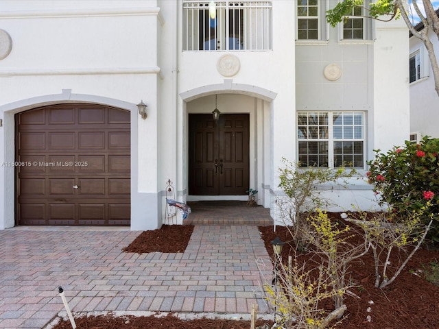 17616 SW 135th Ave, Miami, FL 33177 - view of exterior entry featuring a garage and stucco siding