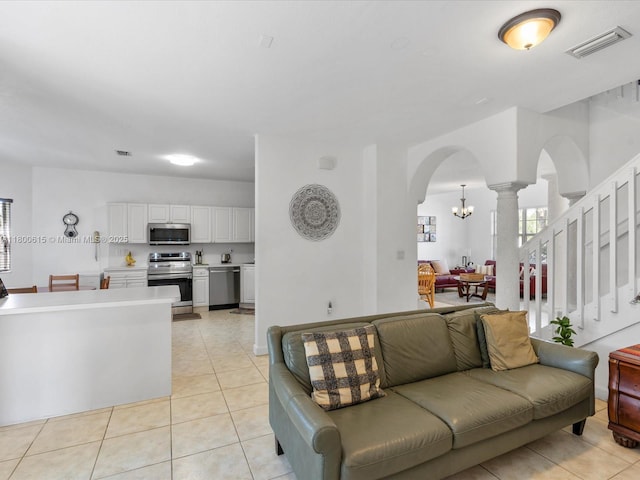 17616 SW 135th Ave, Miami, FL 33177 - living room featuring arched walkways, a chandelier, light tile patterned floors, and ornate columns