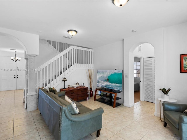 17616 SW 135th Ave, Miami, FL 33177 - living room with arched walkways, light tile patterned floors, and stairway