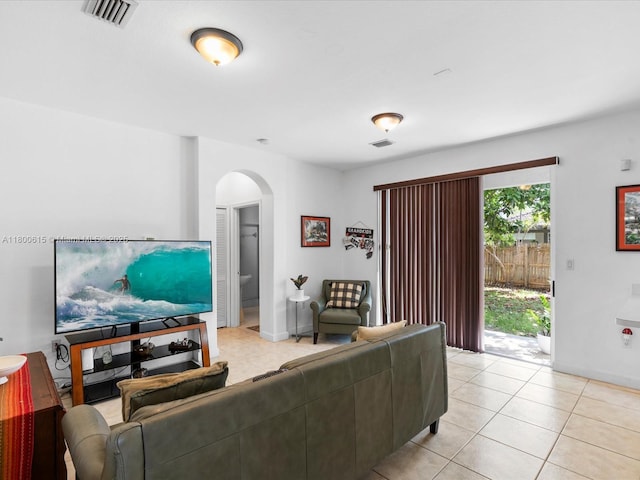 17616 SW 135th Ave, Miami, FL 33177 - living room with arched walkways, light tile patterned floors, and baseboards