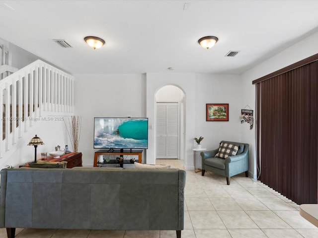 17616 SW 135th Ave, Miami, FL 33177 - living room featuring arched walkways, light tile patterned floors, and stairs