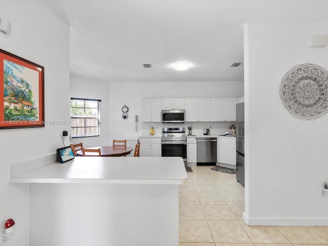 17616 SW 135th Ave, Miami, FL 33177 - kitchen with appliances with stainless steel finishes, white cabinets, light countertops, and light tile patterned floors