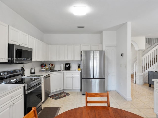 17616 SW 135th Ave, Miami, FL 33177 - kitchen featuring stainless steel appliances, light countertops, white cabinetry, light tile patterned floors, and a sink