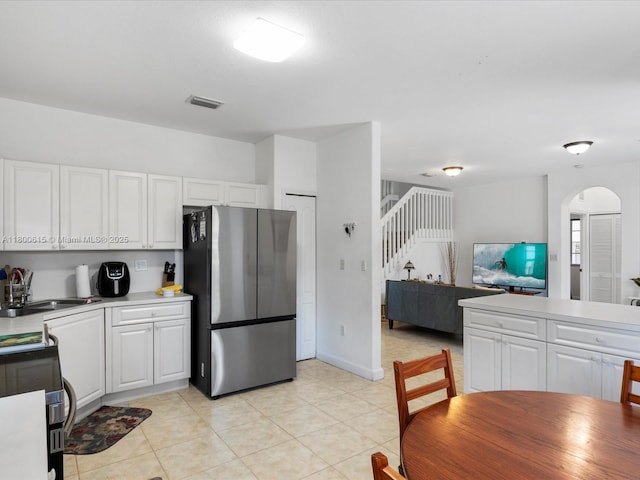 17616 SW 135th Ave, Miami, FL 33177 - kitchen with freestanding refrigerator, a sink, arched walkways, and white cabinets