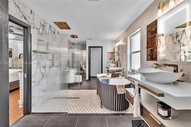 1811 SW 162nd Ave, Miramar, FL 33027 - ensuite bathroom with vanity, a walk in shower, tile patterned floors, and tile walls
