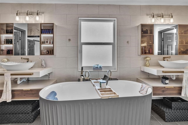 1811 SW 162nd Ave, Miramar, FL 33027 - bathroom featuring tile walls, a freestanding bath, backsplash, and tile patterned floors