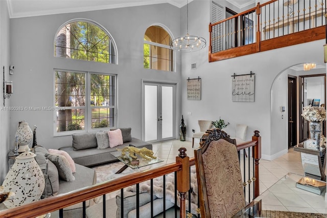 1811 SW 162nd Ave, Miramar, FL 33027 - living room featuring ornamental molding, light tile patterned flooring, a chandelier, arched walkways, and a towering ceiling