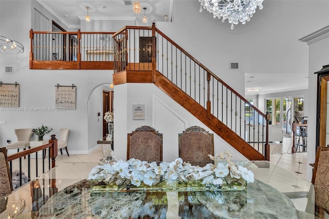 1811 SW 162nd Ave, Miramar, FL 33027 - dining area featuring a chandelier, stairway, a towering ceiling, tile patterned flooring, and arched walkways