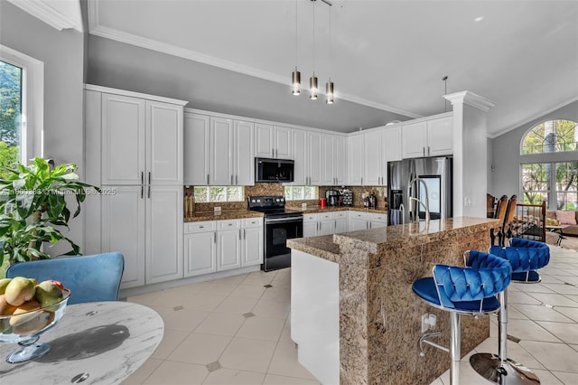 1811 SW 162nd Ave, Miramar, FL 33027 - kitchen with black appliances, ornamental molding, healthy amount of natural light, decorative backsplash, and hanging light fixtures
