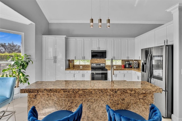 1811 SW 162nd Ave, Miramar, FL 33027 - kitchen featuring stainless steel appliances, healthy amount of natural light, decorative backsplash, ornamental molding, and white cabinets
