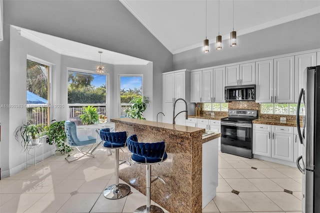1811 SW 162nd Ave, Miramar, FL 33027 - kitchen with stainless steel appliances, backsplash, light tile patterned flooring, pendant lighting, and crown molding