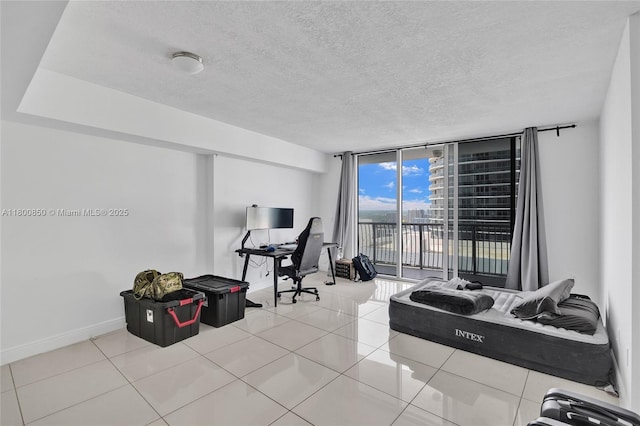 1750 N Bayshore Dr Unit 4007, Miami, FL 33132 - home office with expansive windows, baseboards, light tile patterned flooring, and a textured ceiling
