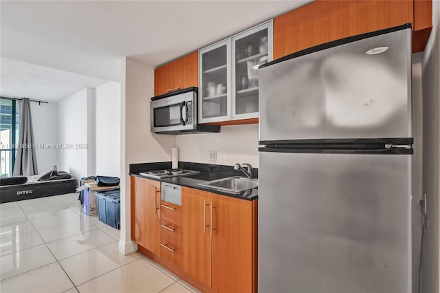 1750 N Bayshore Dr Unit 4007, Miami, FL 33132 - kitchen featuring stainless steel appliances, a sink, dark countertops, glass insert cabinets, and brown cabinets