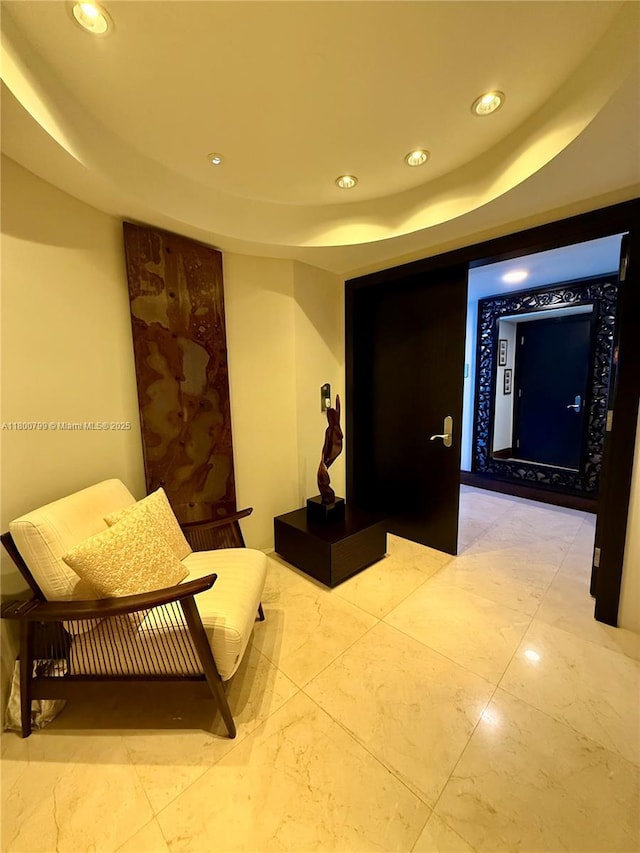 17001 Collins Ave Unit 3005, Sunny Isles Beach, FL 33160 - corridor with recessed lighting, a tray ceiling, and light marble finish floors