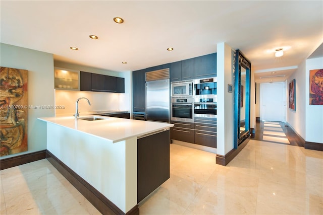 17001 Collins Ave Unit 3005, Sunny Isles Beach, FL 33160 - kitchen featuring built in appliances, a sink, light countertops, a peninsula, and recessed lighting