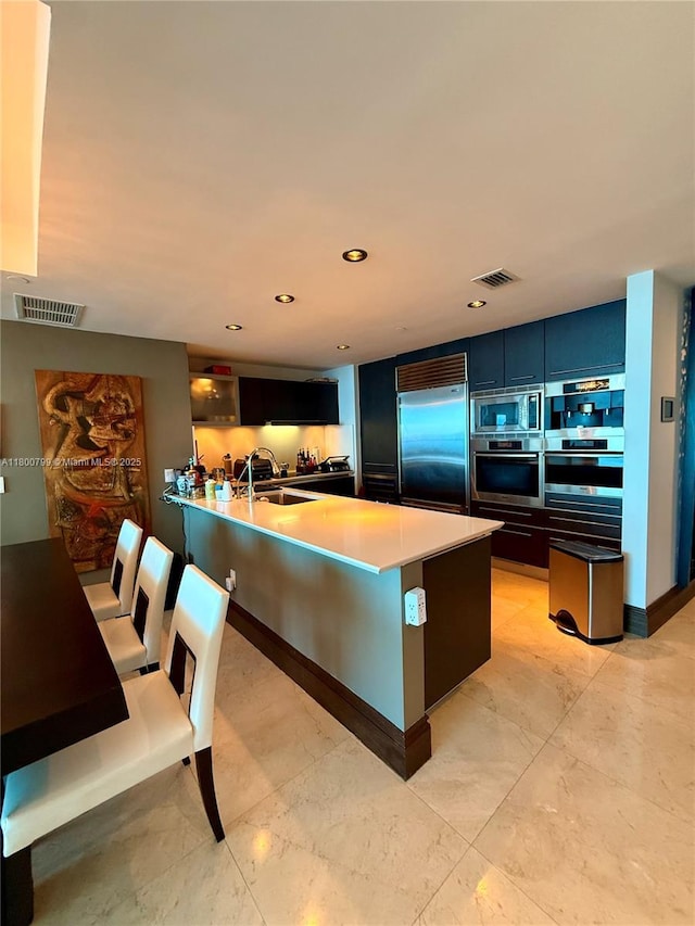 17001 Collins Ave Unit 3005, Sunny Isles Beach, FL 33160 - kitchen with built in appliances, a sink, a peninsula, light countertops, and recessed lighting