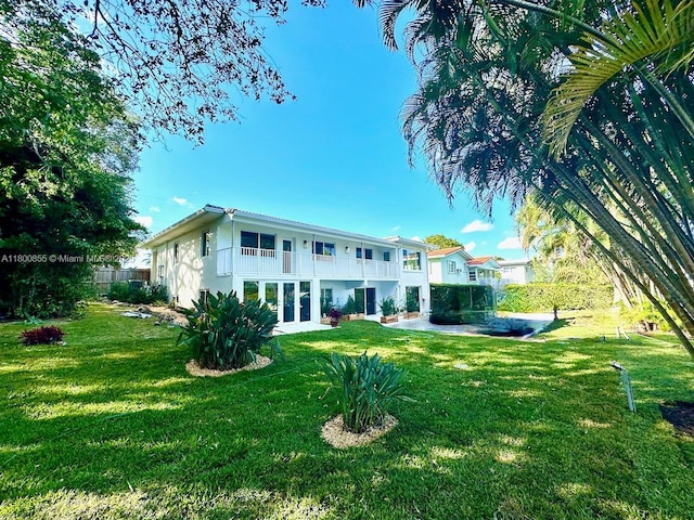 10361 NE 4th Ave, Miami Shores, FL 33138 - back of property featuring a lawn, french doors, and stucco siding