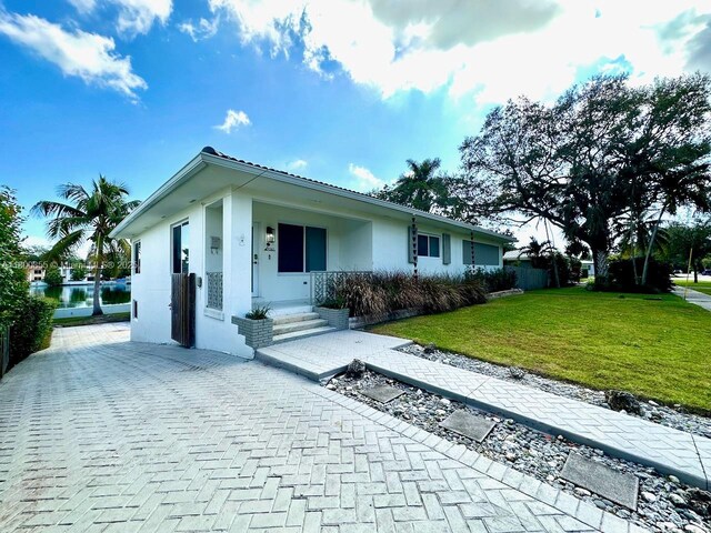 10361 NE 4th Ave, Miami Shores, FL 33138 - ranch-style house featuring stucco siding and a front lawn
